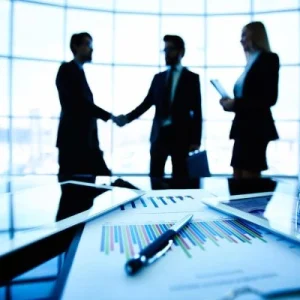 Two business people shaking hands, representing partnership.